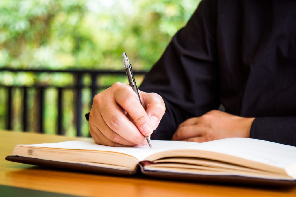Businessman writing book
