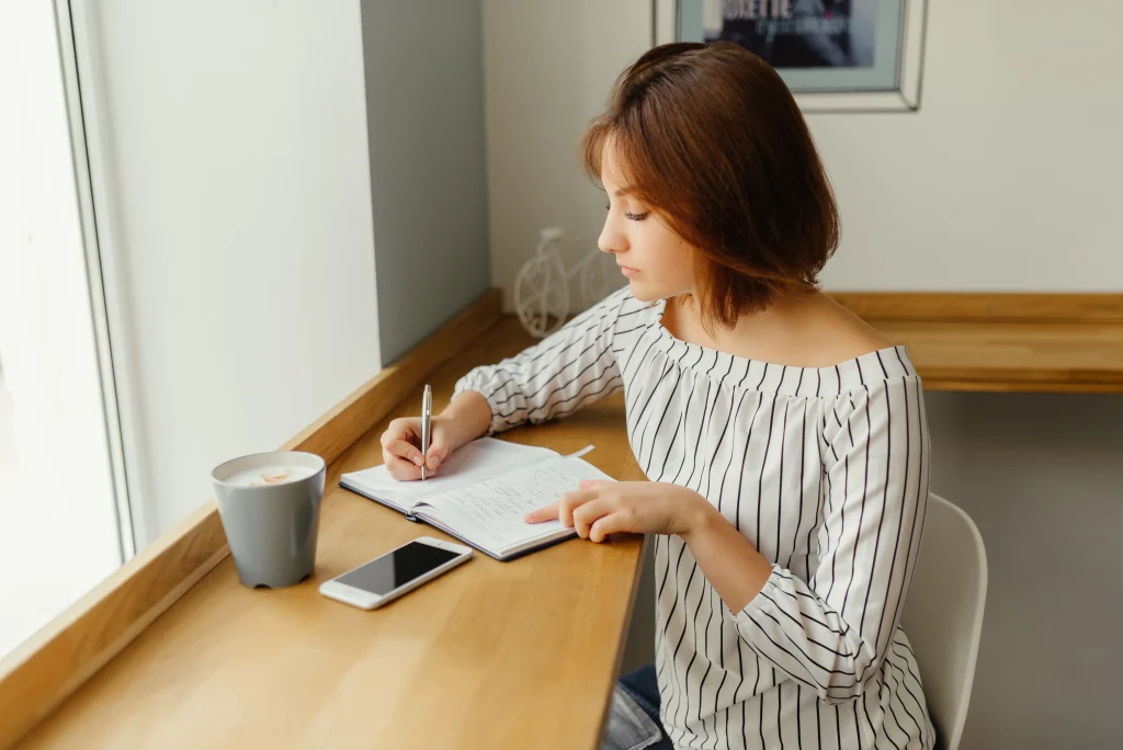 woman writing in a notebook