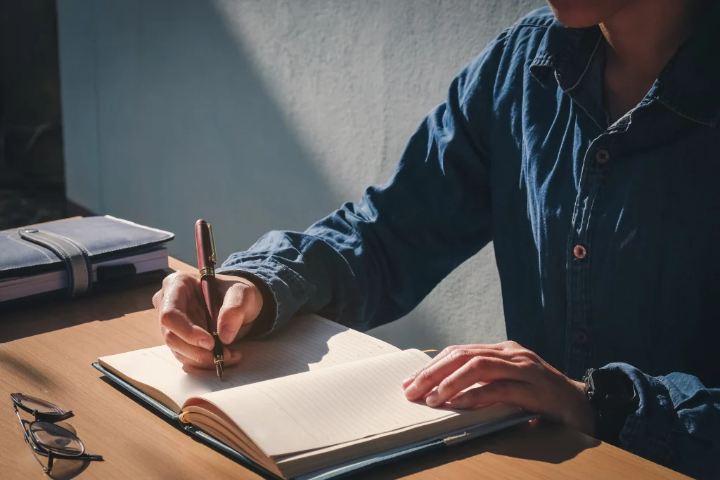 Man writing at desk