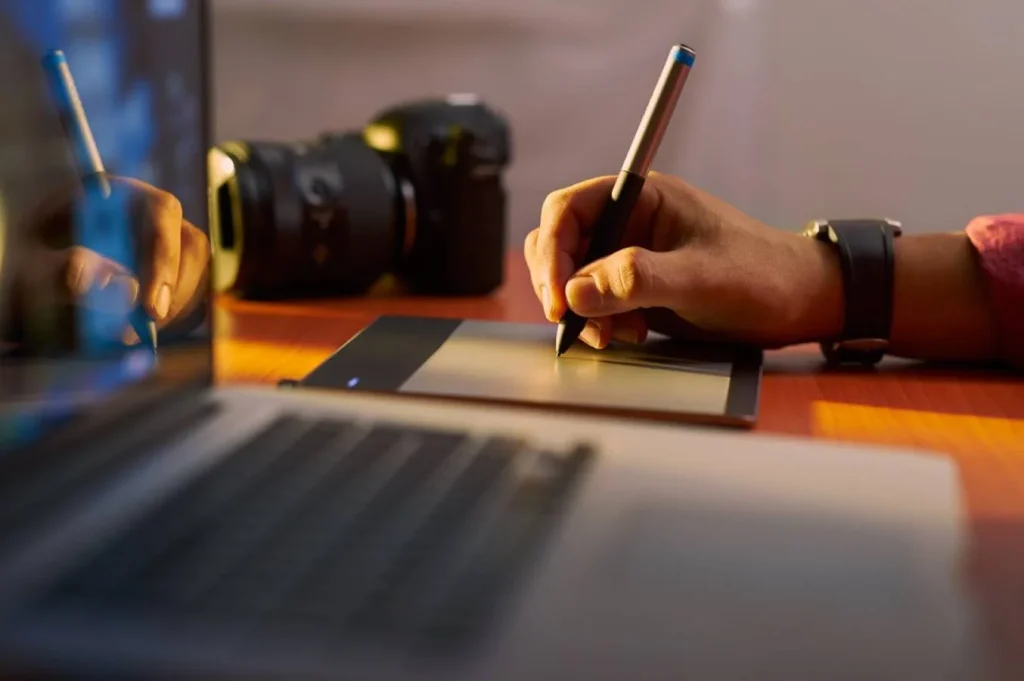 Writer using camera and laptop for content creation